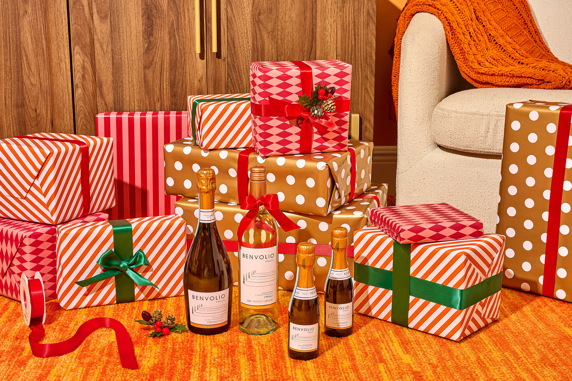 Yellow gingham with three people picnicking and a bottle of Benvolio Prosecco.